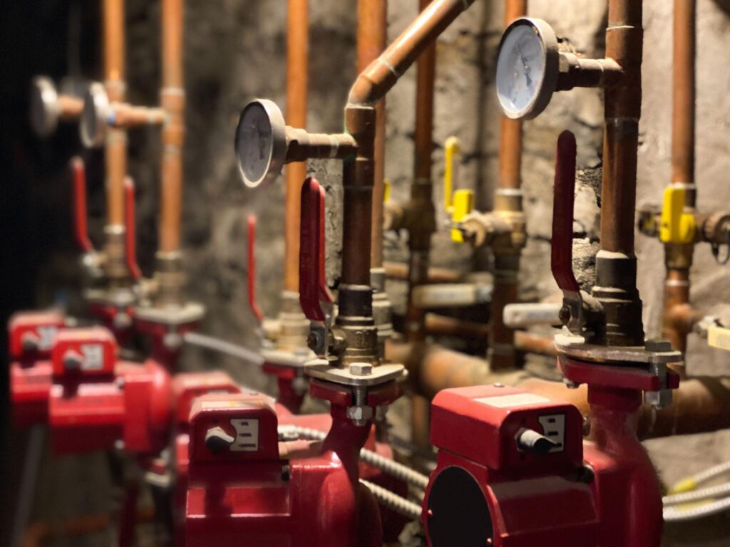 Residential plumbing pipes installed in a basement utility area